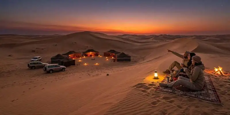 A group of travelers enjoying a campfire and stargazing at a traditional camp, highlighting the Best Time to Go on an Overnight Desert Safari in Jeddah.